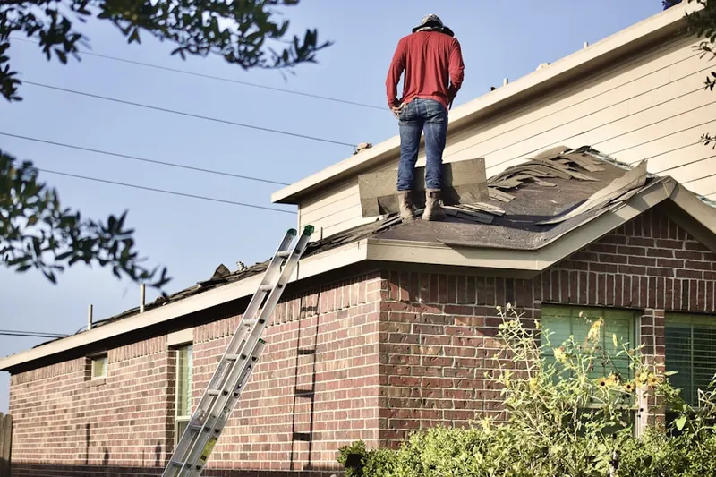 Professional roofer working on a residential roof in Hiwan Hills
